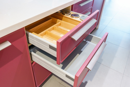 Opened kitchen drawer with plates inside, a smart solution for kitchen storage and organizingの写真素材
