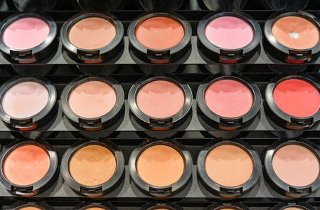 Different shade of crashed blush in a row for make-up of a variety of colors on the standの写真素材