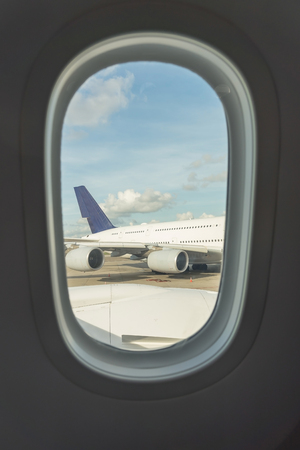 Airplane seat and window inside an aircraftの写真素材