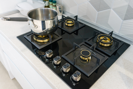 Metal Pot on induction hob in modern kitchen. modern kitchen pot cooking induction electrical stove hob conceptの写真素材