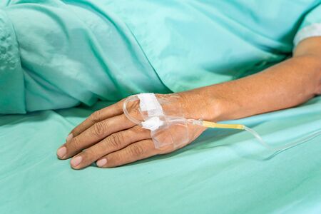 Close up image of IV drip in patient's hand in hospital.の写真素材