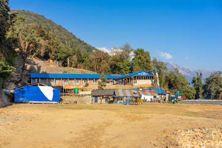 MARDI HIMAL, NEPAL - DECEMBER 30, 2019: View of Forest Camp Guest House & Restaurant on Mardi Himal trek at blue sky, Annapurna mountain range in Nepalのeditorial素材