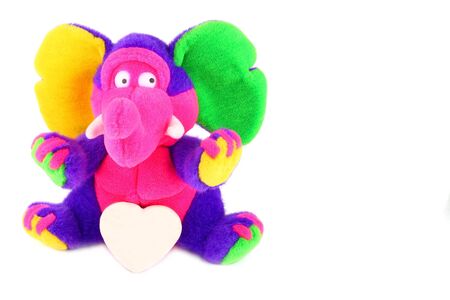 multicolored fluffy elephant with a white shugar heart over whiteの写真素材