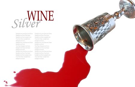Wine poured from a silver goblet on a white backgroundの写真素材