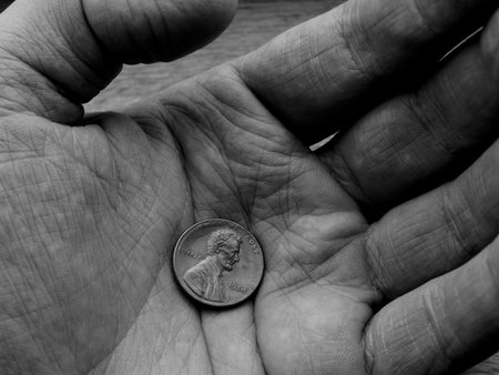 Closeup of The United States one-cent coin on wrinkled hand