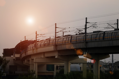 Metro train entering in to the station during sunset under the beautiful cloudscape.のeditorial素材