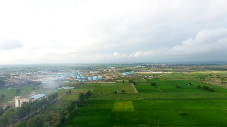 Oil refinery factory in the middle of green fields under the beautiful cloudscape.のeditorial素材