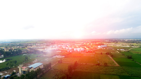 Oil refinery factory in the middle of green fields under the beautiful cloudscape.のeditorial素材