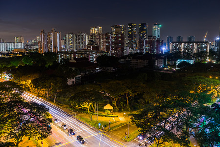 View of the Downtown Singapore skyline, night scene long exposure with traffic and car trails