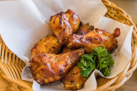 Thai fried chickens Hot and Spicy in basket on wooden tableの写真素材