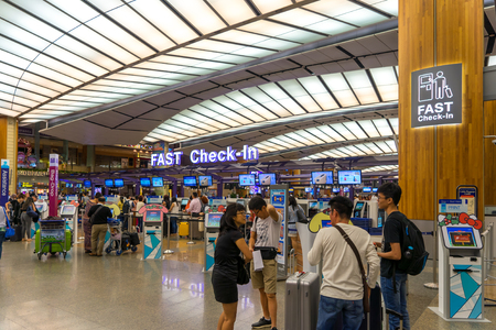 Singapore - December 22, 2017: Visitors walk around Departure Hall in Changi Airport. It has 3 passenger terminals, one of the largest transportation hubs in Asia and serves more than 100 airlines.のeditorial素材