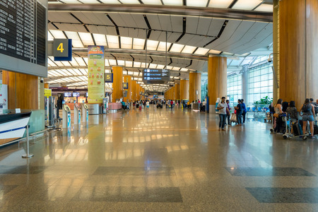 Singapore - January 6, 2018: Visitors walk around Departure Hall in Changi Airport. It has 3 passenger terminals, one of the largest transportation hubs in Asia and serves more than 100 airlinesのeditorial素材