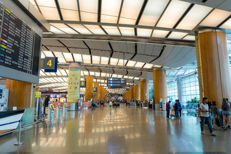Singapore - January 6, 2018: Visitors walk around Departure Hall in Changi Airport. It has 3 passenger terminals, one of the largest transportation hubs in Asia and serves more than 100 airlinesのeditorial素材