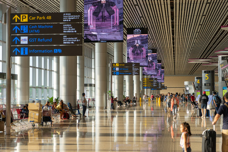 Singapore - Julyy 14, 2018: Visitors walk around Departure Hall in Changi Airport. It has 4 passenger terminals, one of the largest transportation hubs in Asia and serves more than 100 airlinesのeditorial素材