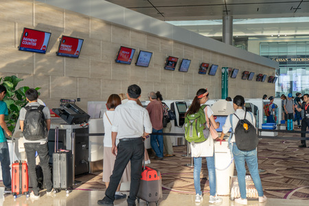 Singapore - Julyy 14, 2018: Visitors walk around Departure Hall in Changi Airport. It has 4 passenger terminals, one of the largest transportation hubs in Asia and serves more than 100 airlinesのeditorial素材