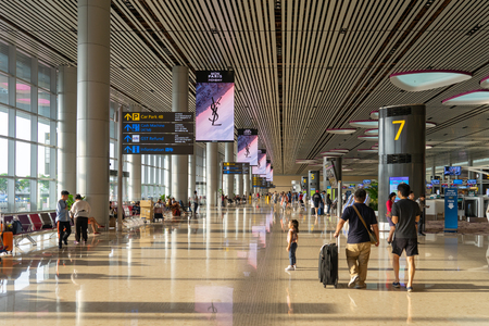 Singapore - Julyy 14, 2018: Visitors walk around Departure Hall in Changi Airport. It has 4 passenger terminals, one of the largest transportation hubs in Asia and serves more than 100 airlinesのeditorial素材
