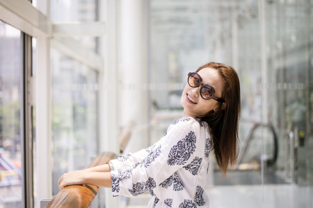 Beautiful young woman smiling and happy in shopping centerの写真素材