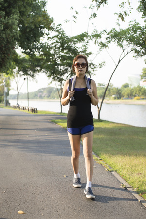 Young women walking exercise at park when eveningの写真素材