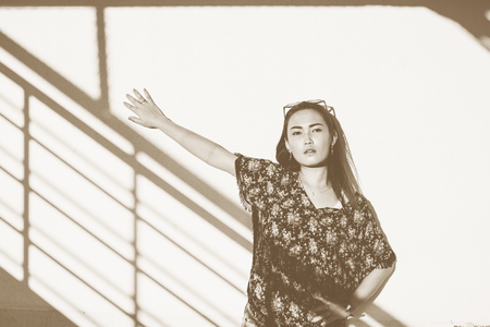 Asian woman wearing a shawl in monochrome with sepia toningの写真素材