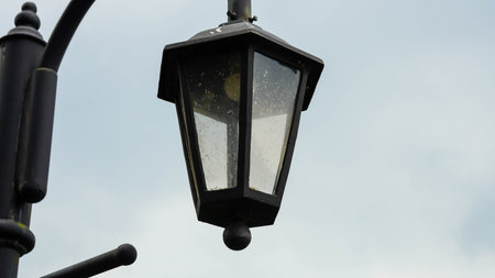 Old lamp lantern on the stone wall , process in vintage style.