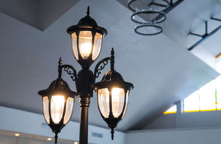 Old lamp lantern on the stone wall , process in vintage style in selective focusの写真素材