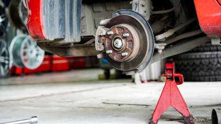 Changing a wheels red car in selective focusの写真素材