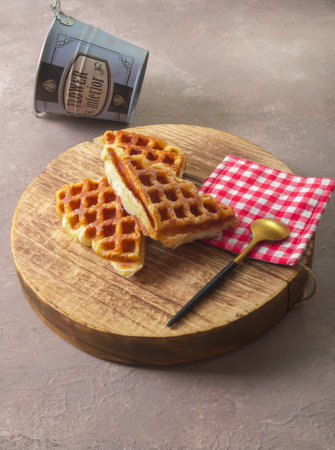 Stack of Croissant Waffle or Croffle served in round wood surface plate. Selective focus image.の写真素材