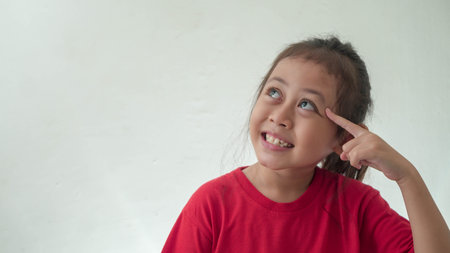 Little Asian Girl looks get idea in selective focusの写真素材