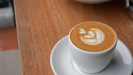 macchiato coffee on wooden desk in coffee shop in selective focus
