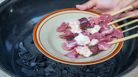 Grilled pork and beef skewer on a plate in the restaurantの写真素材