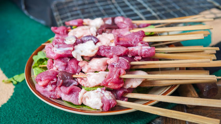 Thai style pork skewer on wooden table, Thai street foodの写真素材