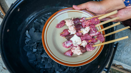 Pork skewers on a plate in the kitchen of a restaurantの写真素材