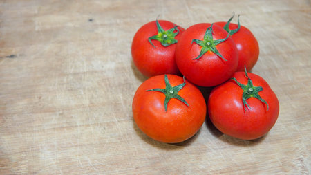 Tomatoes on a cutting board on a wooden background. Selective focus.の写真素材