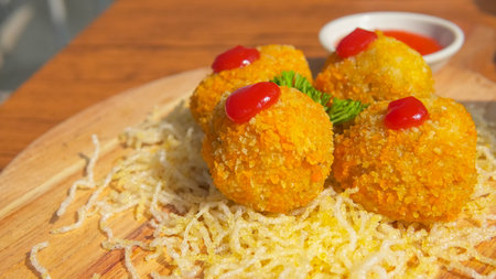 Crispy fried rice balls with ketchup and mayonnaiseの写真素材