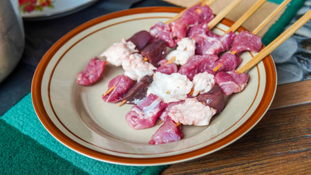Meat skewers with pork, beef and lamb on a plate.の写真素材