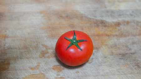 Tomato on wooden background. Close up of fresh red tomato.の写真素材