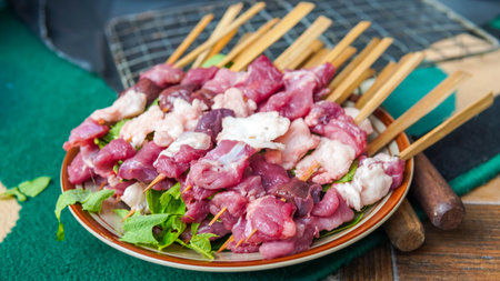 Raw pork and beef skewers on a plate on the table.の写真素材