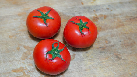Ripe red tomatoes on a wooden cutting board. Selective focus.の写真素材