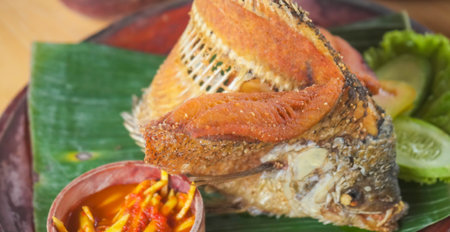 Fried fish with spicy sauce on banana leaf,indonesian food