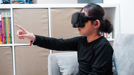 Asian woman wearing virtual reality goggles in living room at home. Technology concept.