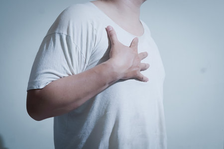 Man suffering from pain in the back and shoulder. Health care concept.の写真素材