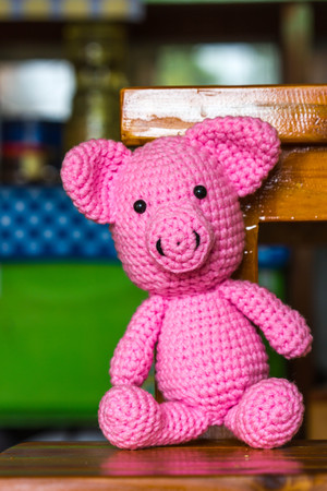 Single pig doll on a wood deskの写真素材