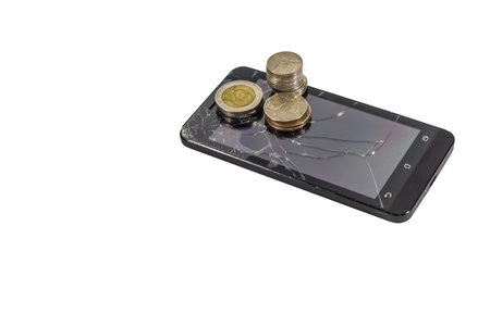 The coins and broken screen phoneの写真素材