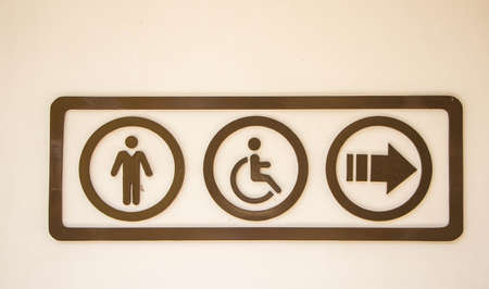 A sign showing the man or  disabled can go follow the arrowの写真素材