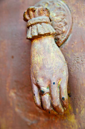 close up of female hand old doorknockerの写真素材