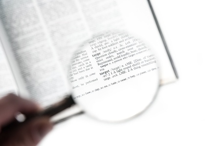 A magnifying glass on the word target on a dictionary