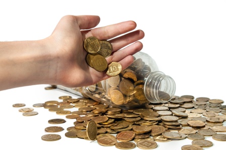 Human hand is pouring the coins, white background