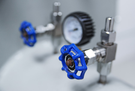 Closeup of pressure gauge and blue valve