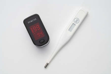 Top view of portable digital fingertip oximeter and thermometer