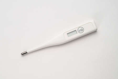 Top view of white thermometer on white background